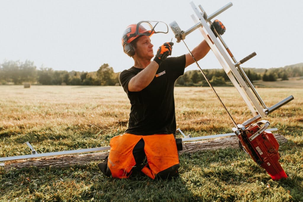 Granberg Alaskan MKIV chainsaw mill milling a large log in the forest