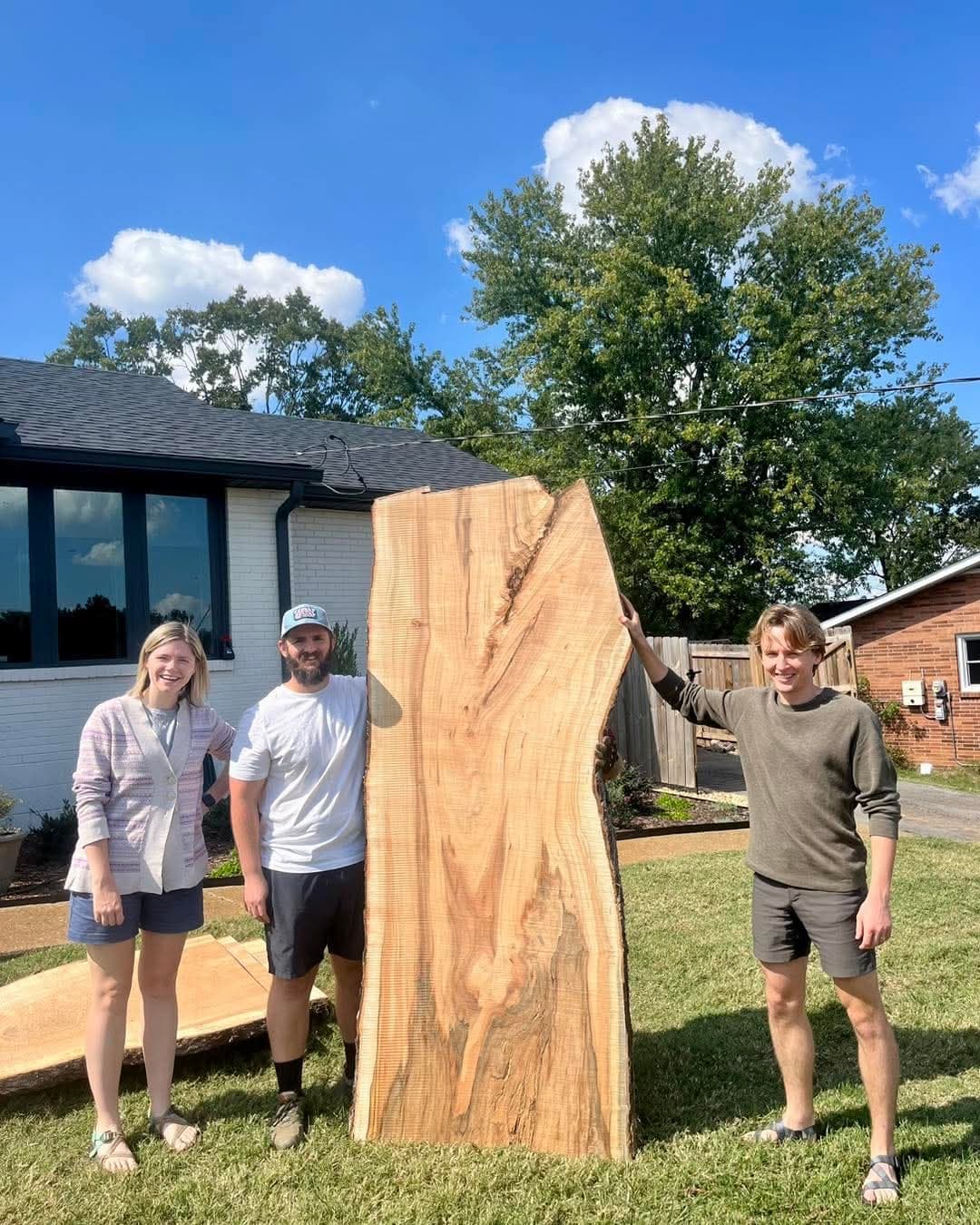 A live-edge slab taller than the people who milled it