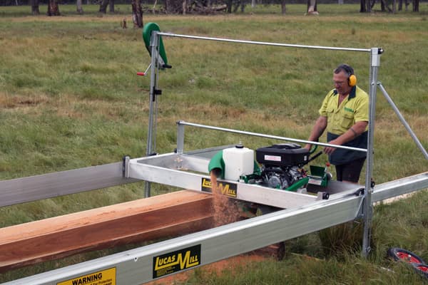 Operator running a Lucas Mill 6-18 along its track in a paddock