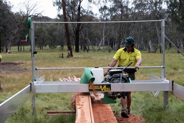 Lucas Mill 7-23 swing-blade sawmill cutting on its track