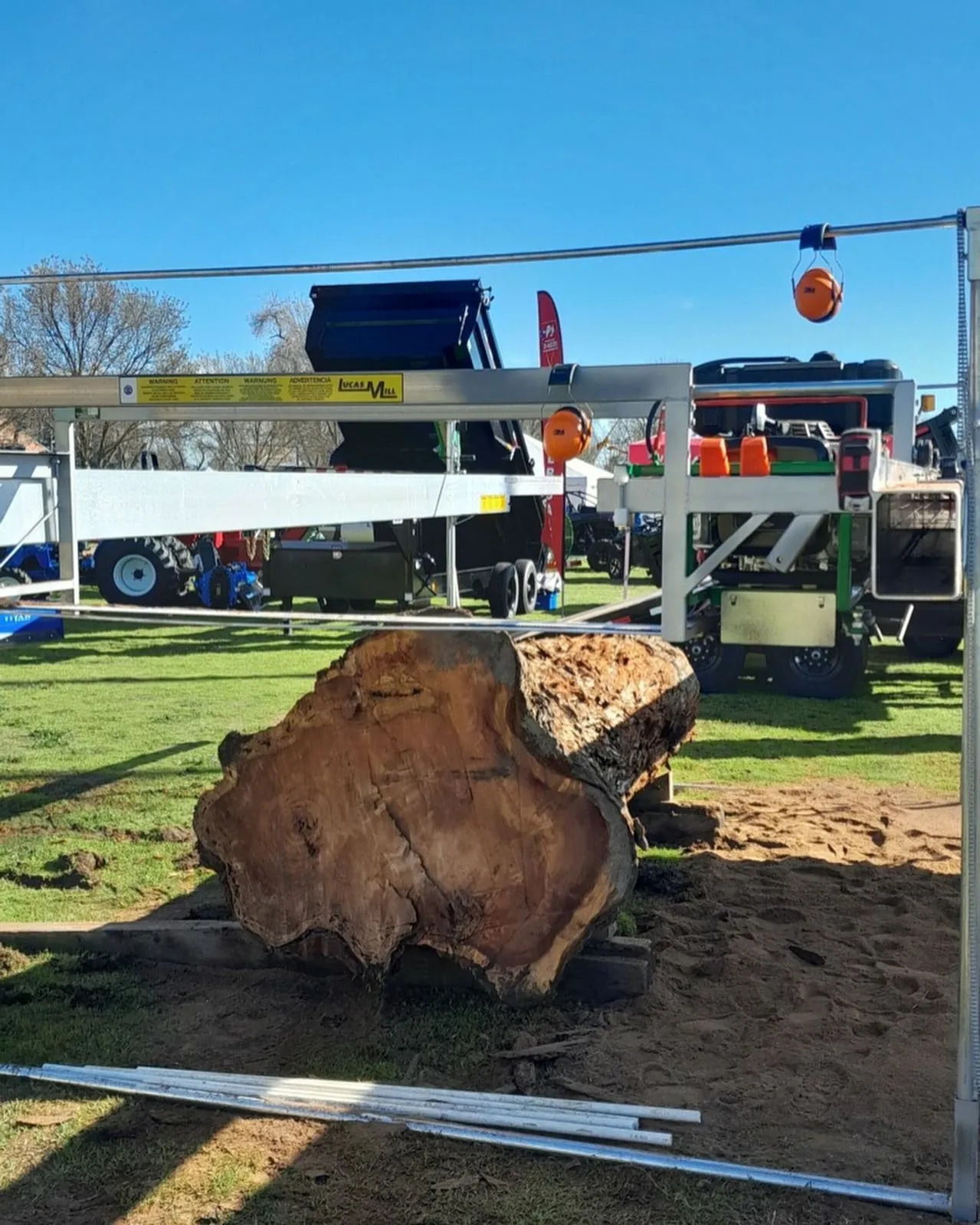 Large burl log set up under a Lucas Mill at an outdoor show