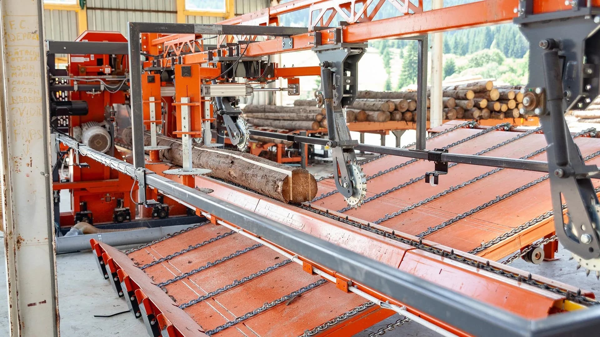 Wood-Mizer TVSHD twin vertical sawmill line with its log deck inside a mill